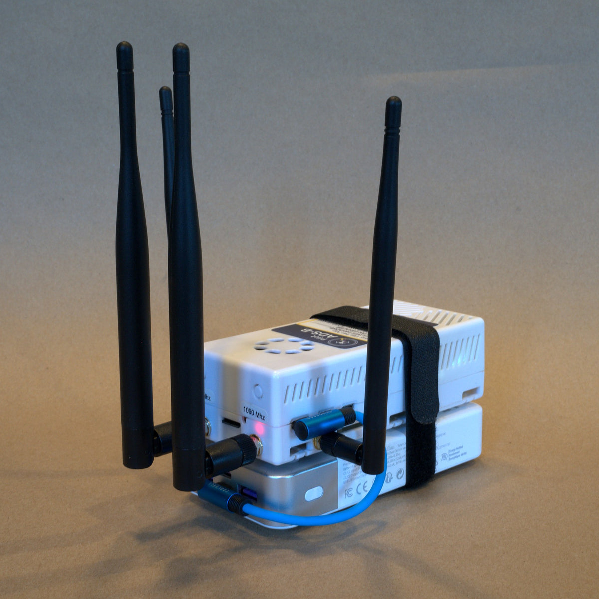 Rear three-quarter view showing the antenna connectors and the short power cable