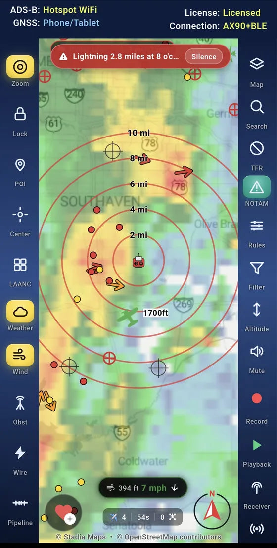 A lightning warning banner over weather radar, with lightning strikes and traffic around the pilot