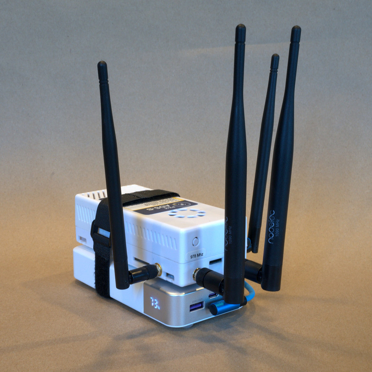 The Remote ID receiver and battery held together by the strap, side view
